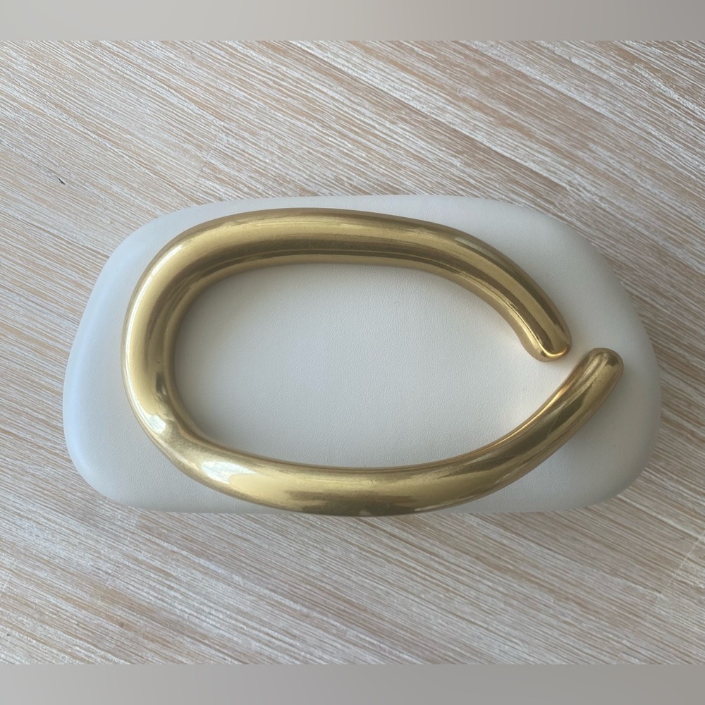 Cream Clutch with Gold Handle. Removable gold strap.